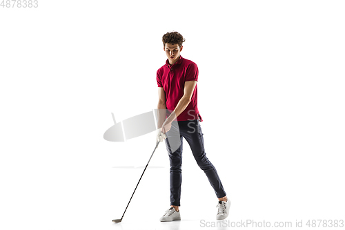 Image of Golf player in a red shirt training, practicing isolated on white studio background