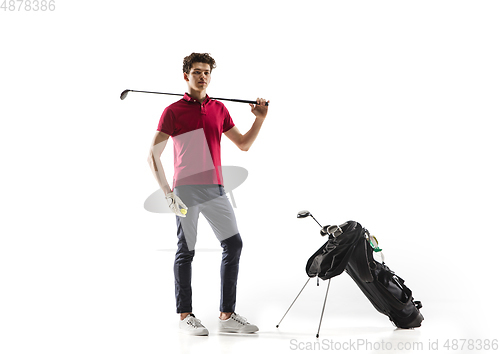 Image of Golf player in a red shirt training, practicing isolated on white studio background