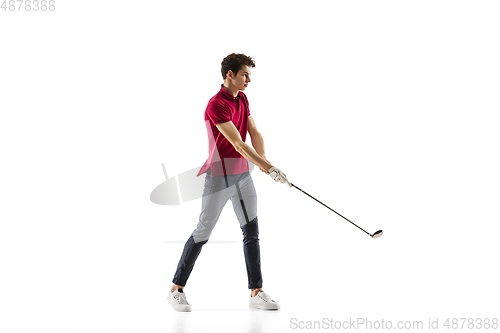 Image of Golf player in a red shirt taking a swing isolated on white studio background