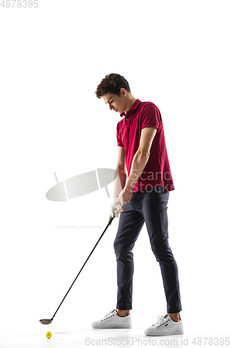 Image of Golf player in a red shirt training, practicing isolated on white studio background