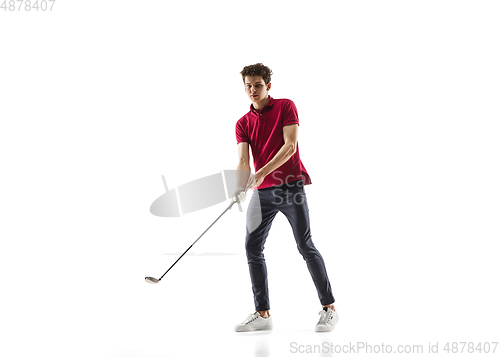 Image of Golf player in a red shirt training, practicing isolated on white studio background