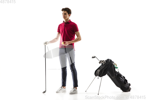 Image of Golf player in a red shirt training, practicing isolated on white studio background