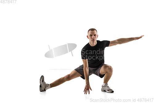 Image of Young caucasian male model in action, motion isolated on white background. Concept of sport, movement, energy and dynamic, healthy lifestyle. Training, practicing.