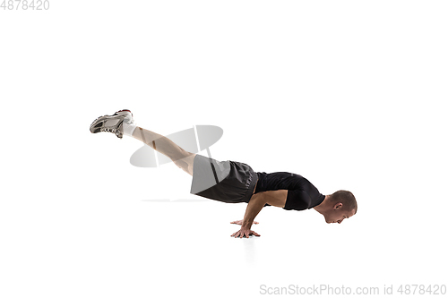 Image of Young caucasian male model in action, motion isolated on white background. Concept of sport, movement, energy and dynamic, healthy lifestyle. Training, practicing.