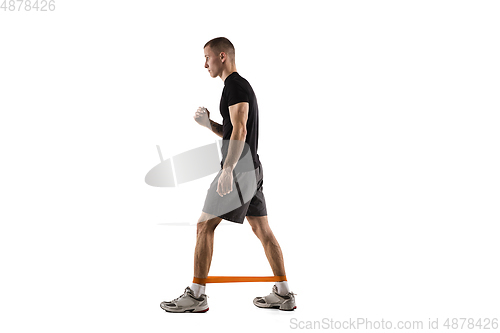 Image of Young caucasian male model in action, motion isolated on white background. Concept of sport, movement, energy and dynamic, healthy lifestyle. Training, practicing.