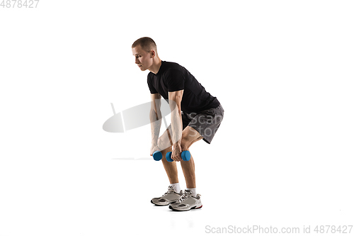 Image of Young caucasian male model in action, motion isolated on white background. Concept of sport, movement, energy and dynamic, healthy lifestyle. Training, practicing.
