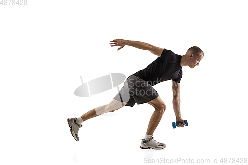 Image of Young caucasian male model in action, motion isolated on white background. Concept of sport, movement, energy and dynamic, healthy lifestyle. Training, practicing.