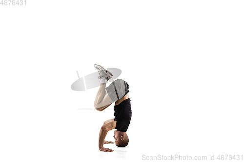 Image of Young caucasian male model in action, motion isolated on white background. Concept of sport, movement, energy and dynamic, healthy lifestyle. Training, practicing.