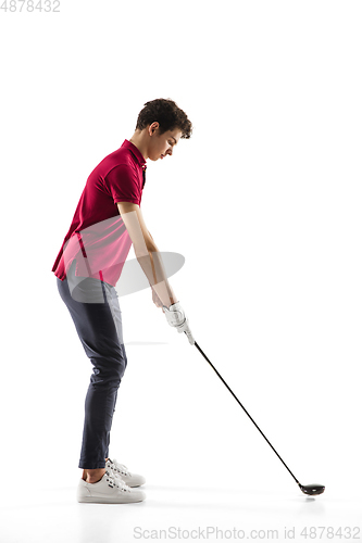 Image of Golf player in a red shirt training, practicing isolated on white studio background