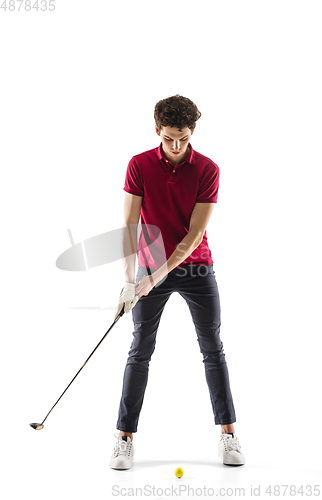 Image of Golf player in a red shirt taking a swing isolated on white studio background