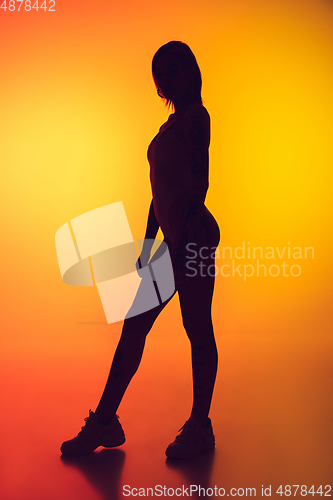 Image of Portrait of young caucasian woman on gradient yellow background with copyspace, unusual and freaky appearance