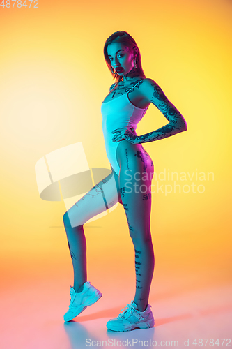 Image of Portrait of young caucasian woman on gradient yellow background with copyspace, unusual and freaky appearance