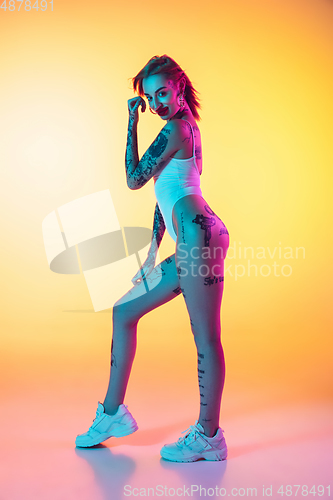 Image of Portrait of young caucasian woman on gradient yellow background with copyspace, unusual and freaky appearance