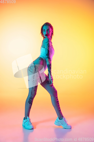 Image of Portrait of young caucasian woman on gradient yellow background with copyspace, unusual and freaky appearance