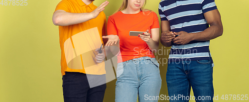 Image of Group of friends using mobile smartphones. Teenagers addiction to new technology trends. Close up.