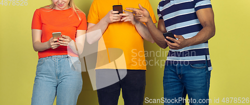 Image of Group of friends using mobile smartphones. Teenagers addiction to new technology trends. Close up.