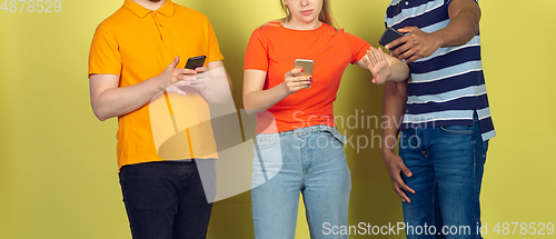 Image of Group of friends using mobile smartphones. Teenagers addiction to new technology trends. Close up.