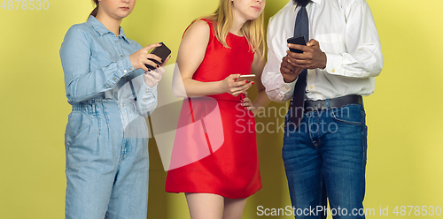 Image of Group of friends using mobile smartphones. Teenagers addiction to new technology trends. Close up.