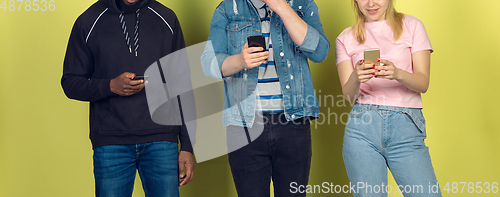 Image of Group of friends using mobile smartphones. Teenagers addiction to new technology trends. Close up.