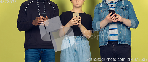 Image of Group of friends using mobile smartphones. Teenagers addiction to new technology trends. Close up.