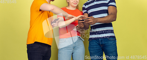 Image of Group of friends using mobile smartphones. Teenagers addiction to new technology trends. Close up.