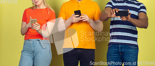 Image of Group of friends using mobile smartphones. Teenagers addiction to new technology trends. Close up.