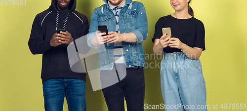 Image of Group of friends using mobile smartphones. Teenagers addiction to new technology trends. Close up.