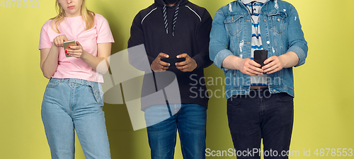 Image of Group of friends using mobile smartphones. Teenagers addiction to new technology trends. Close up.