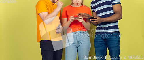 Image of Group of friends using mobile smartphones. Teenagers addiction to new technology trends. Close up.