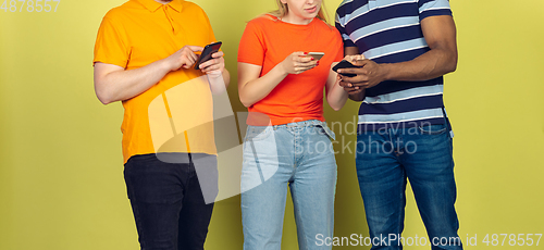 Image of Group of friends using mobile smartphones. Teenagers addiction to new technology trends. Close up.