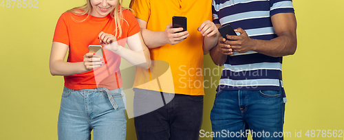 Image of Group of friends using mobile smartphones. Teenagers addiction to new technology trends. Close up.