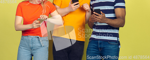 Image of Group of friends using mobile smartphones. Teenagers addiction to new technology trends. Close up.