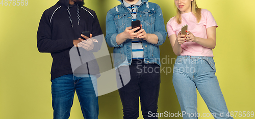 Image of Group of friends using mobile smartphones. Teenagers addiction to new technology trends. Close up.