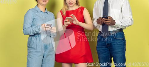 Image of Group of friends using mobile smartphones. Teenagers addiction to new technology trends. Close up.