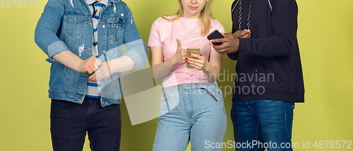 Image of Group of friends using mobile smartphones. Teenagers addiction to new technology trends. Close up.