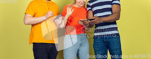 Image of Group of friends using mobile smartphones. Teenagers addiction to new technology trends. Close up.