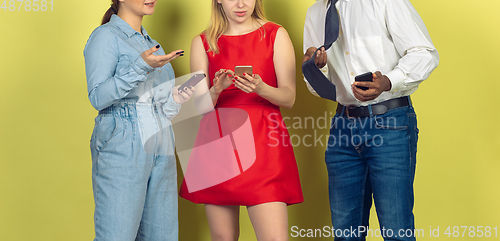 Image of Group of friends using mobile smartphones. Teenagers addiction to new technology trends. Close up.