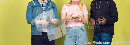 Image of Group of friends using mobile smartphones. Teenagers addiction to new technology trends. Close up.