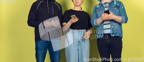 Image of Group of friends using mobile smartphones. Teenagers addiction to new technology trends. Close up.