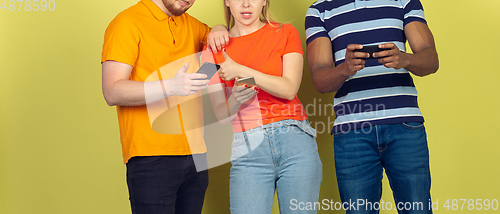 Image of Group of friends using mobile smartphones. Teenagers addiction to new technology trends. Close up.