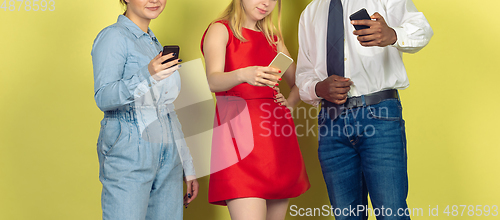 Image of Group of friends using mobile smartphones. Teenagers addiction to new technology trends. Close up.
