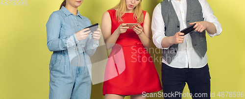 Image of Group of friends using mobile smartphones. Teenagers addiction to new technology trends. Close up.