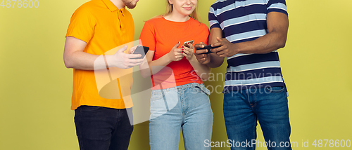 Image of Group of friends using mobile smartphones. Teenagers addiction to new technology trends. Close up.