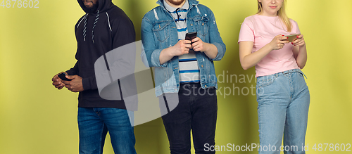 Image of Group of friends using mobile smartphones. Teenagers addiction to new technology trends. Close up.