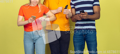 Image of Group of friends using mobile smartphones. Teenagers addiction to new technology trends. Close up.