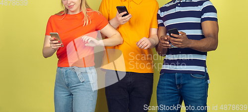 Image of Group of friends using mobile smartphones. Teenagers addiction to new technology trends. Close up.