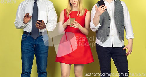 Image of Group of friends using mobile smartphones. Teenagers addiction to new technology trends. Close up.