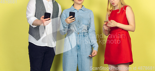 Image of Group of friends using mobile smartphones. Teenagers addiction to new technology trends. Close up.