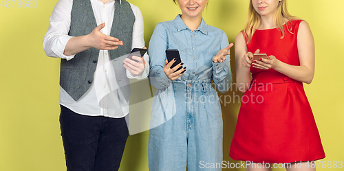 Image of Group of friends using mobile smartphones. Teenagers addiction to new technology trends. Close up.