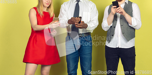 Image of Group of friends using mobile smartphones. Teenagers addiction to new technology trends. Close up.